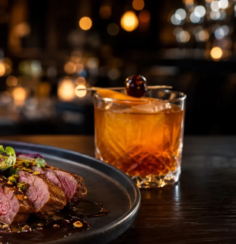Restaurant table with food and a drink, the guest experience behind the website